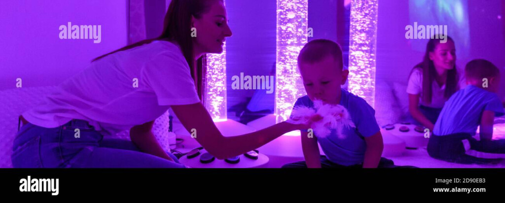 Child With Intellectual Disability And His Therapist In Sensory 