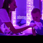 Child With Intellectual Disability And His Therapist In Sensory